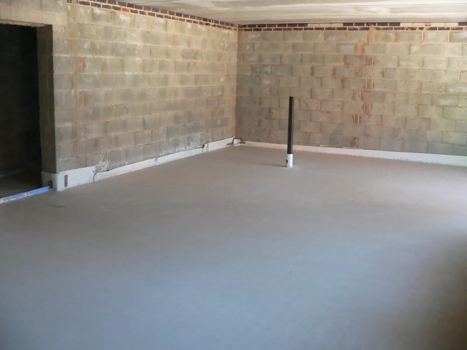 Finished screed over an acoustic floor in an apartment block at Hinckley
